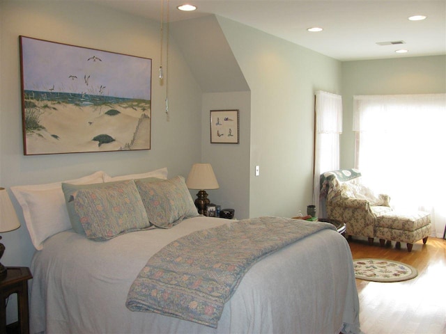 bedroom with wood-type flooring and lofted ceiling