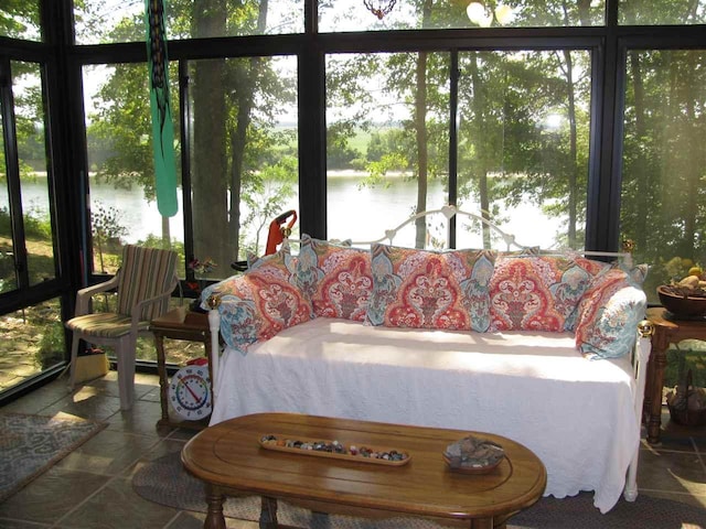 sunroom / solarium featuring a water view