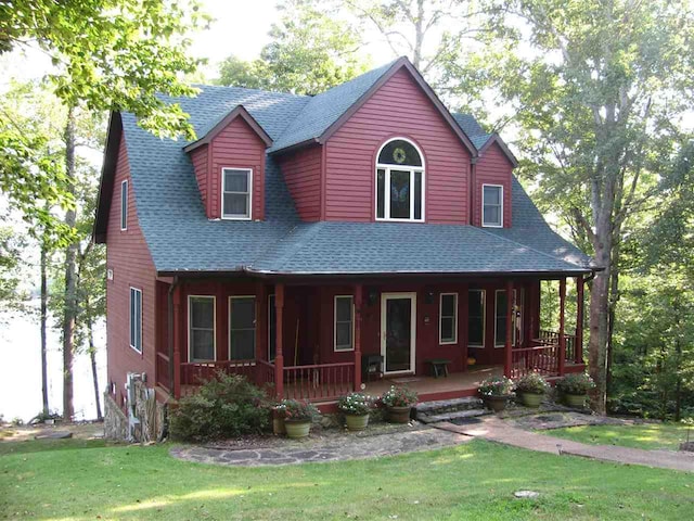 view of front of home with a front yard and a porch