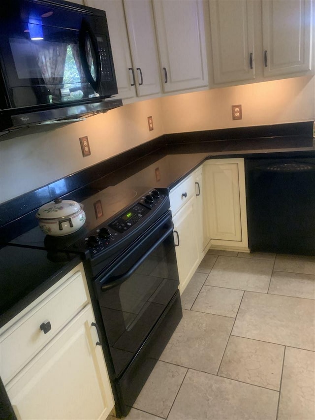 kitchen featuring white cabinets, light tile floors, and black appliances