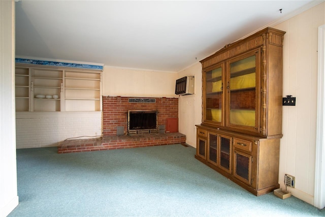 unfurnished living room with light carpet, a wall unit AC, ornamental molding, and a fireplace