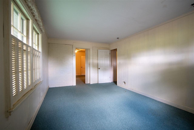 unfurnished bedroom featuring a closet, dark carpet, and ornamental molding