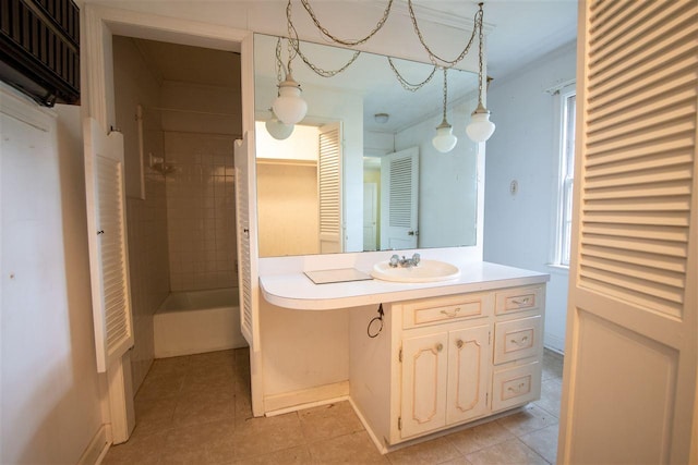 bathroom with tile flooring, tiled shower, and vanity