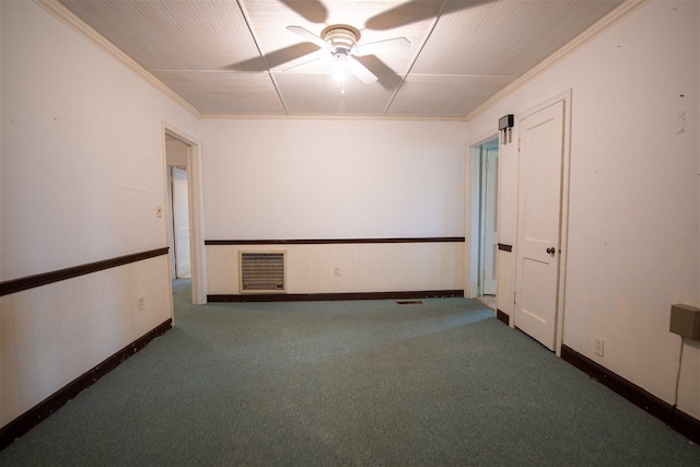 empty room featuring ornamental molding, ceiling fan, and dark colored carpet