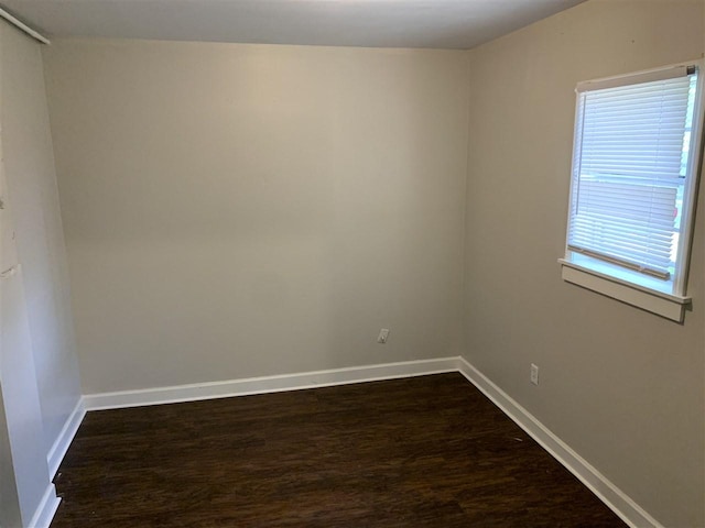 spare room with dark hardwood / wood-style floors