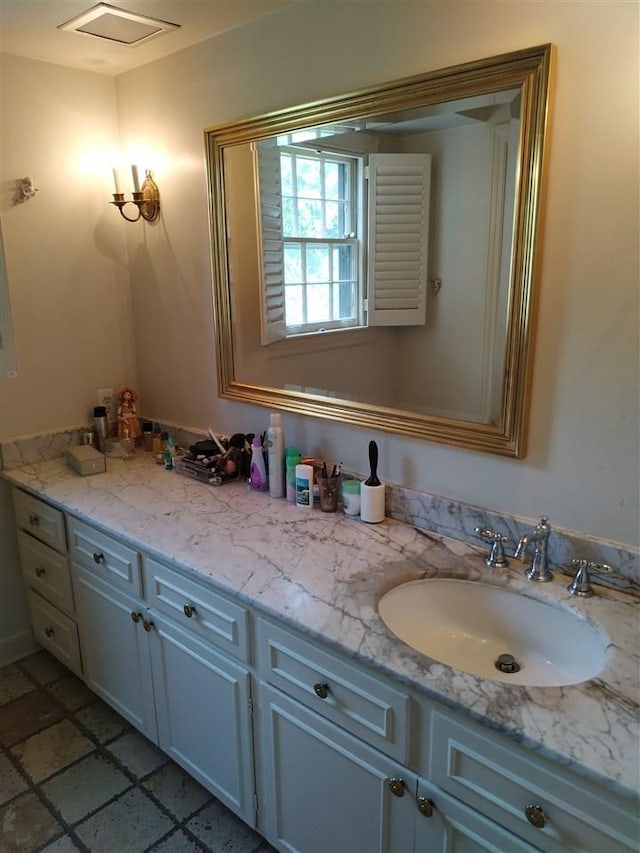 bathroom with tile floors and vanity