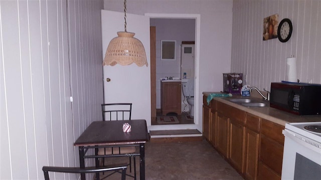 kitchen featuring pendant lighting, sink, and electric range