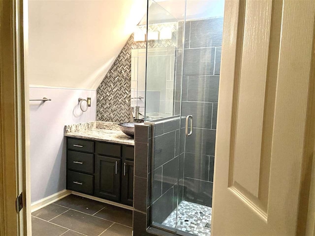 bathroom with tile flooring, vanity, and an enclosed shower