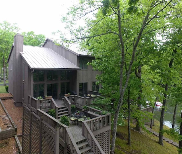 rear view of property featuring a deck