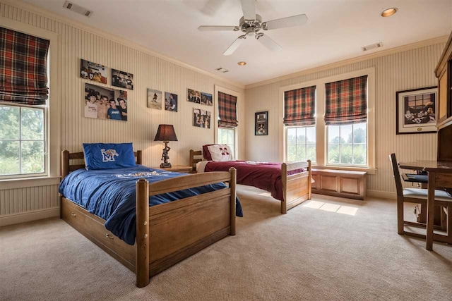 carpeted bedroom with ceiling fan and crown molding