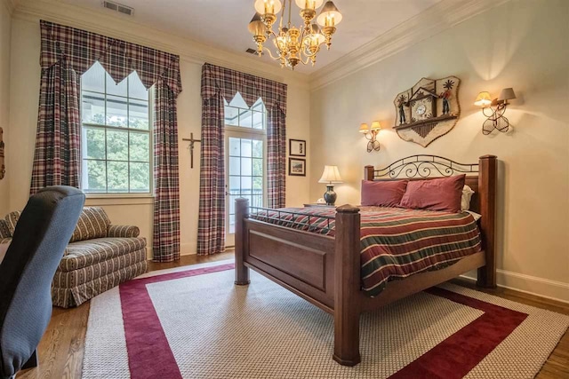 bedroom with crown molding, wood-type flooring, and a notable chandelier