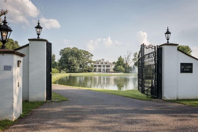 view of gate with a water view