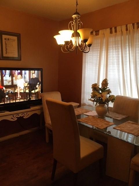 dining area with an inviting chandelier and dark wood-type flooring