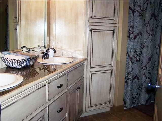 bathroom featuring tile floors and dual bowl vanity