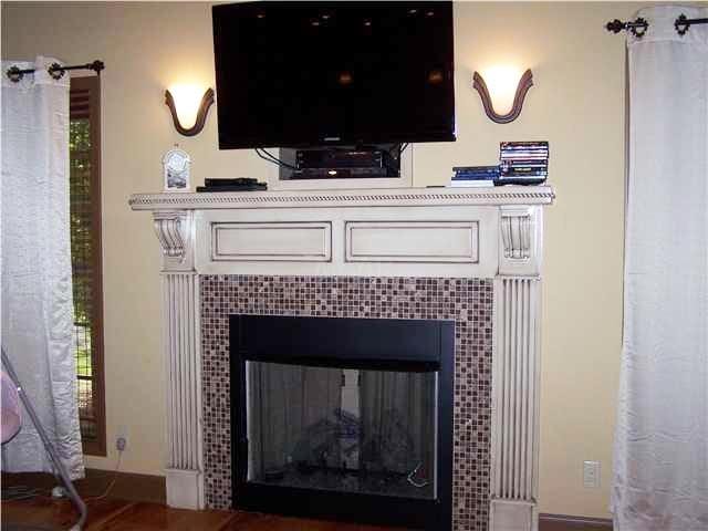 room details featuring a tiled fireplace