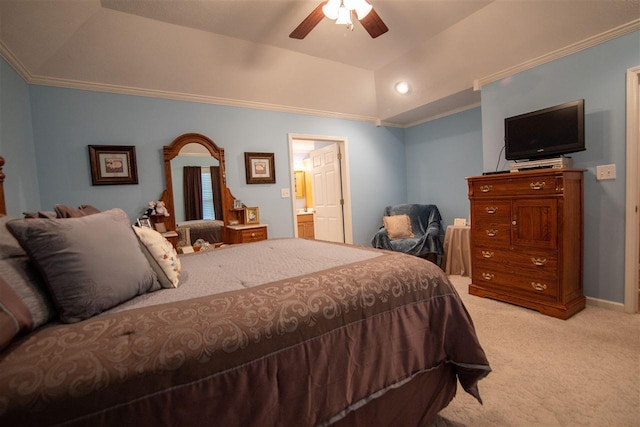 bedroom featuring light carpet, ensuite bathroom, ceiling fan, and a tray ceiling