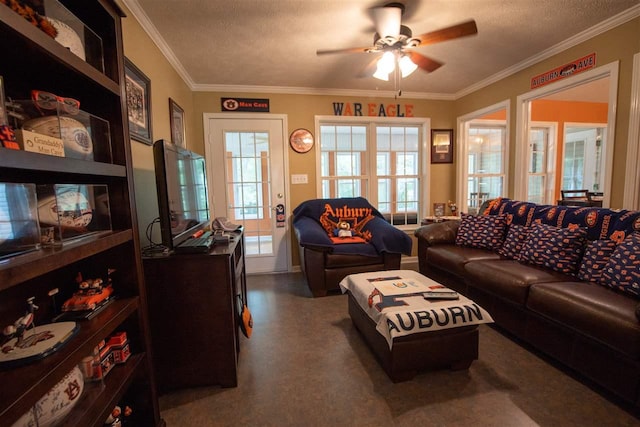 living room featuring ceiling fan, a textured ceiling, ornamental molding, and a healthy amount of sunlight