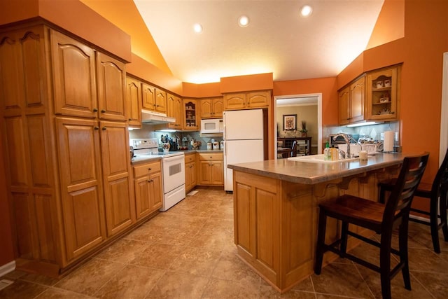 kitchen with light tile floors, a breakfast bar, white appliances, lofted ceiling, and sink