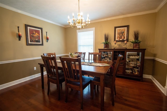 dining area featuring dark hardwood / wood-style flooring, crown molding, and an inviting chandelier