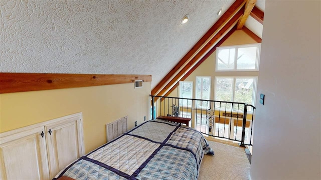 bedroom featuring a textured ceiling and vaulted ceiling with beams