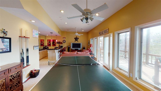 recreation room with light carpet, plenty of natural light, and ceiling fan