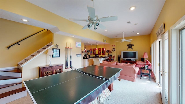 playroom featuring light carpet and ceiling fan