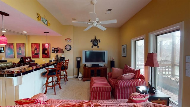 living room with light carpet and ceiling fan