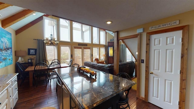 dining area with vaulted ceiling with beams, dark hardwood / wood-style floors, and an inviting chandelier