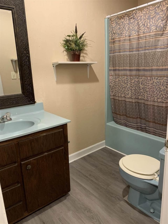 full bathroom with shower / bath combination with curtain, toilet, vanity, and wood-type flooring