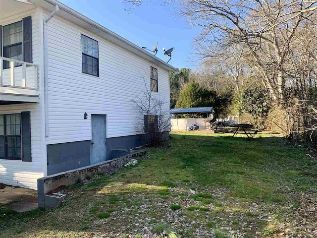 view of property exterior with a yard