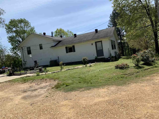 back of house with a lawn