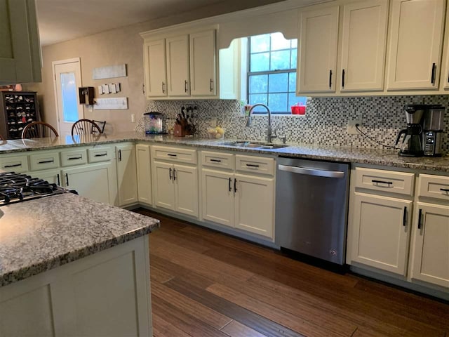 kitchen featuring dark hardwood / wood-style floors, sink, light stone counters, white cabinets, and stainless steel dishwasher