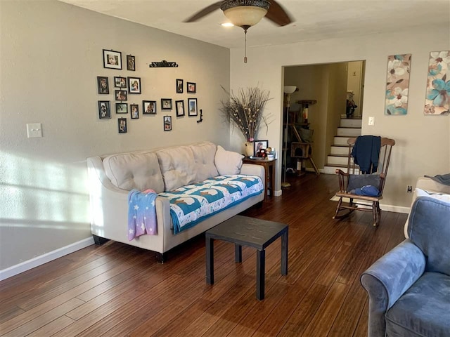 living room featuring ceiling fan and dark hardwood / wood-style floors