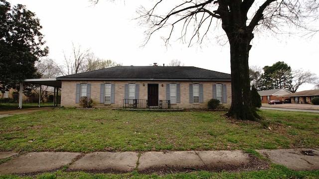 view of front facade with a carport and a front yard