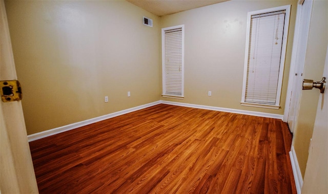 empty room with wood-type flooring