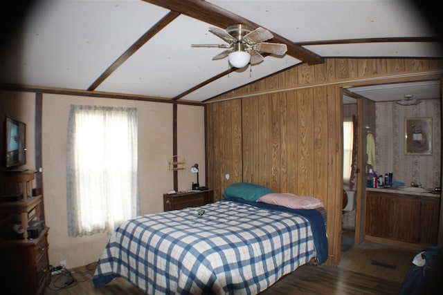 bedroom with wooden walls, lofted ceiling with beams, ceiling fan, and wood-type flooring