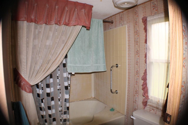 bathroom with toilet and shower / bathtub combination with curtain