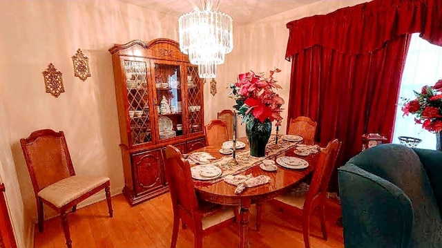 dining room featuring a notable chandelier and light wood-type flooring