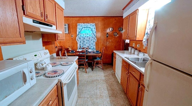 kitchen with light tile flooring, white appliances, a textured ceiling, and sink