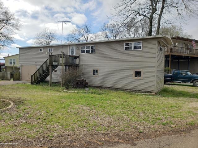 rear view of house featuring a yard