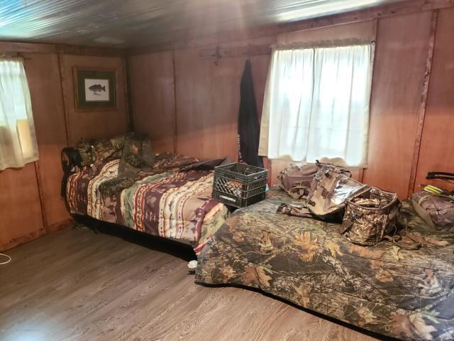 bedroom with light hardwood / wood-style flooring and multiple windows