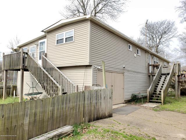 rear view of property with a wooden deck