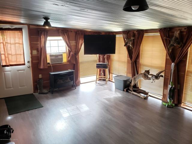 misc room featuring dark hardwood / wood-style flooring and a wood stove