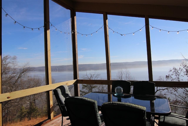 sunroom / solarium with a water view