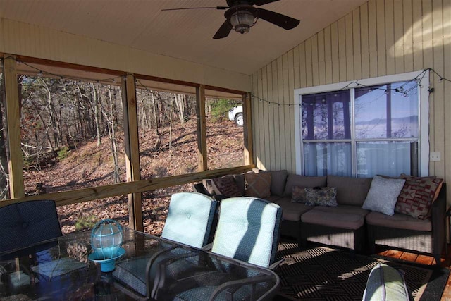 sunroom / solarium featuring ceiling fan and lofted ceiling