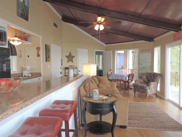 interior space with light wood-type flooring, wood ceiling, ceiling fan, and lofted ceiling with beams