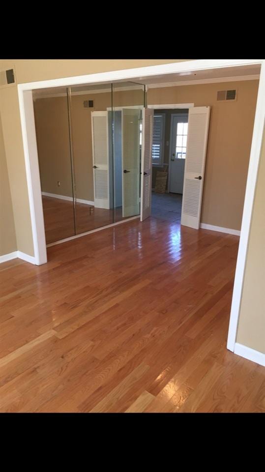 spare room with wood-type flooring