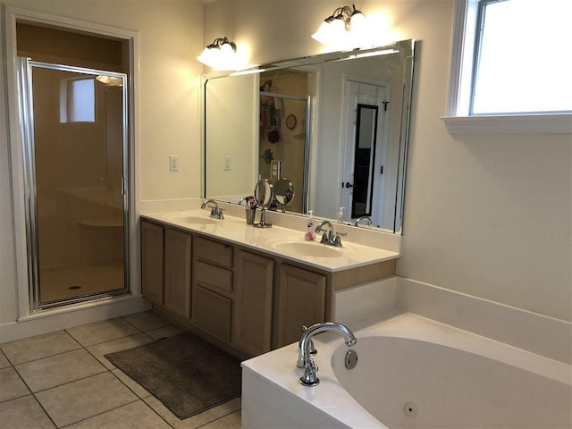 bathroom featuring tile floors, independent shower and bath, and double vanity