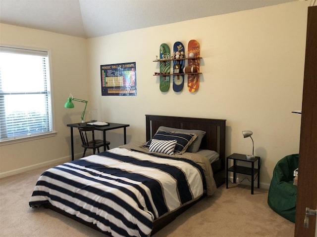 carpeted bedroom with vaulted ceiling