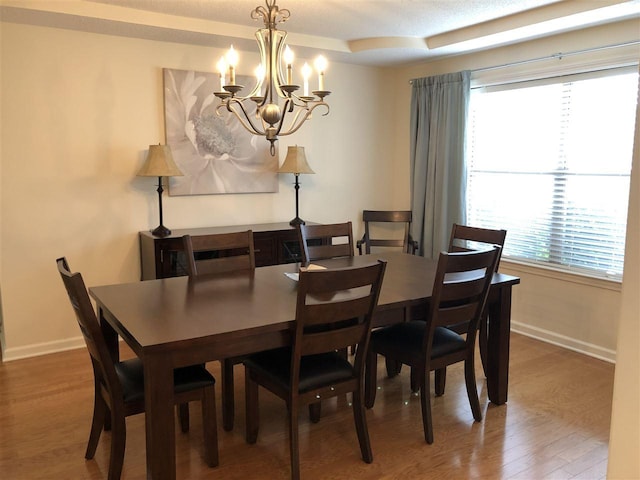 dining space with a notable chandelier and wood-type flooring